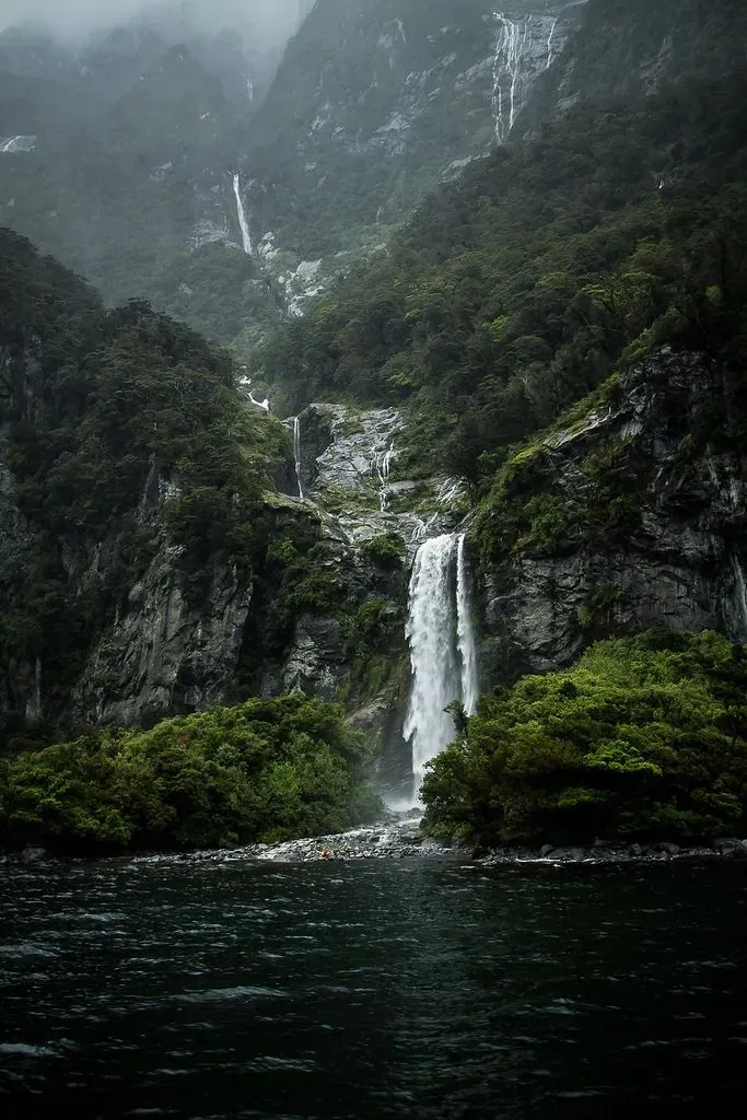 A misty waterfall cascading down a mountainside