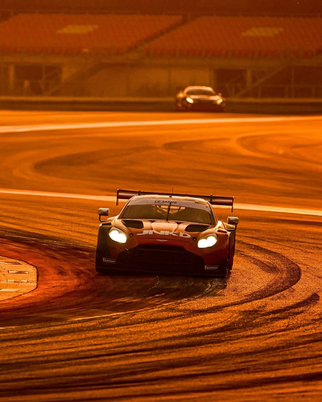 GT3 race car cornering at dusk