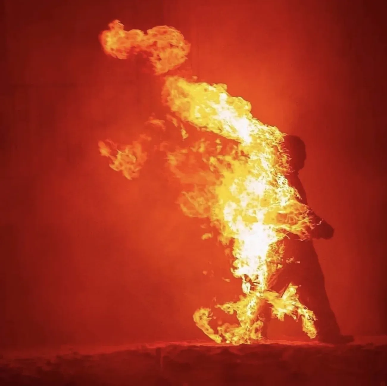 A stunt performer engulfed in flame mid-action
